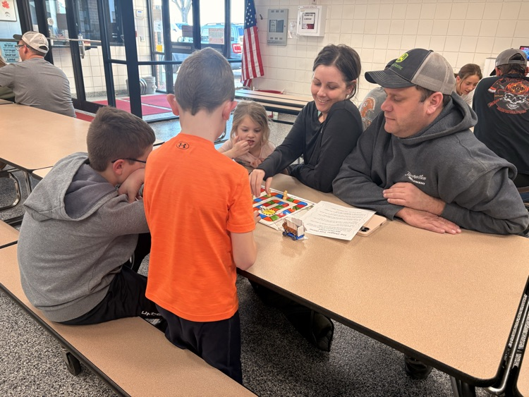 students and their families playing games