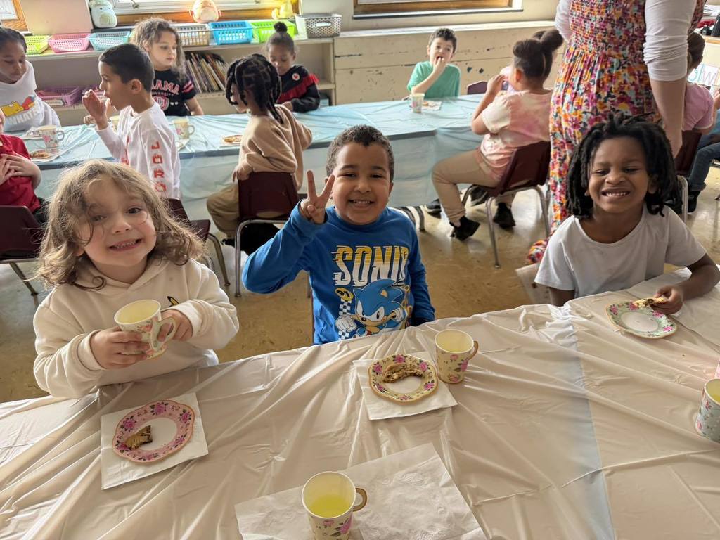 Kids eating cookies and drinking juice. 