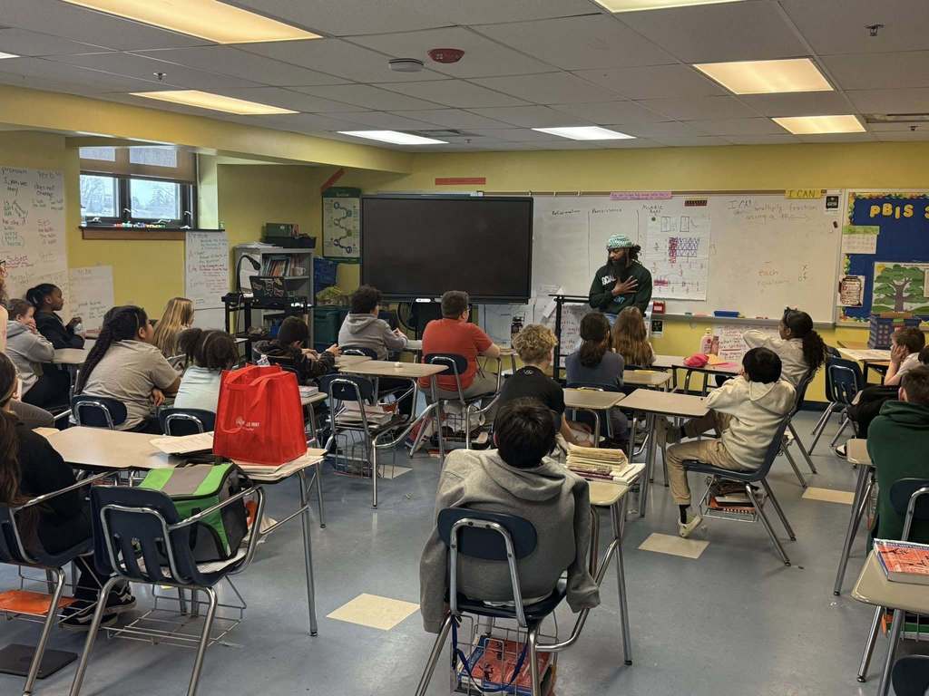 A speaker talking to a classroom.