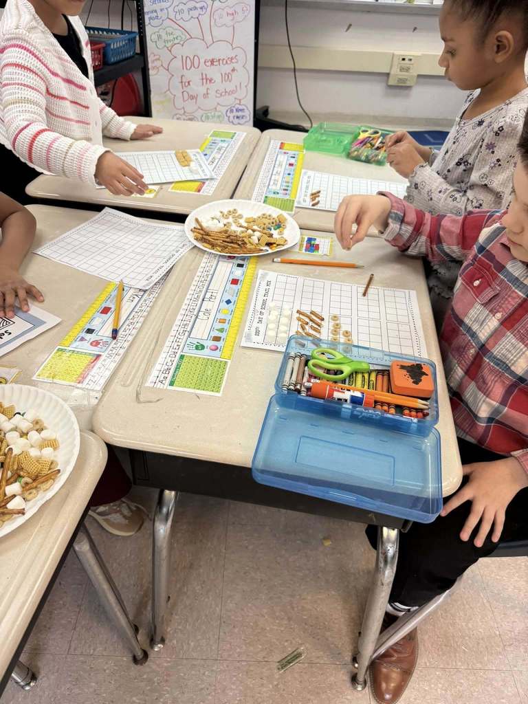 Kids taking snacks and putting them on a paper for a project.