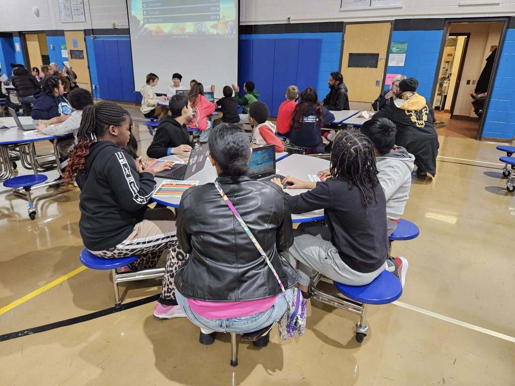 Kids and adults sitting at circle tables,