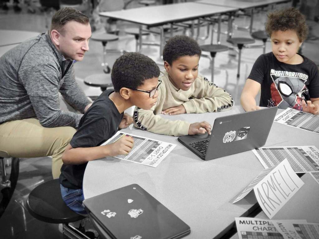 Kids working on a laptop.