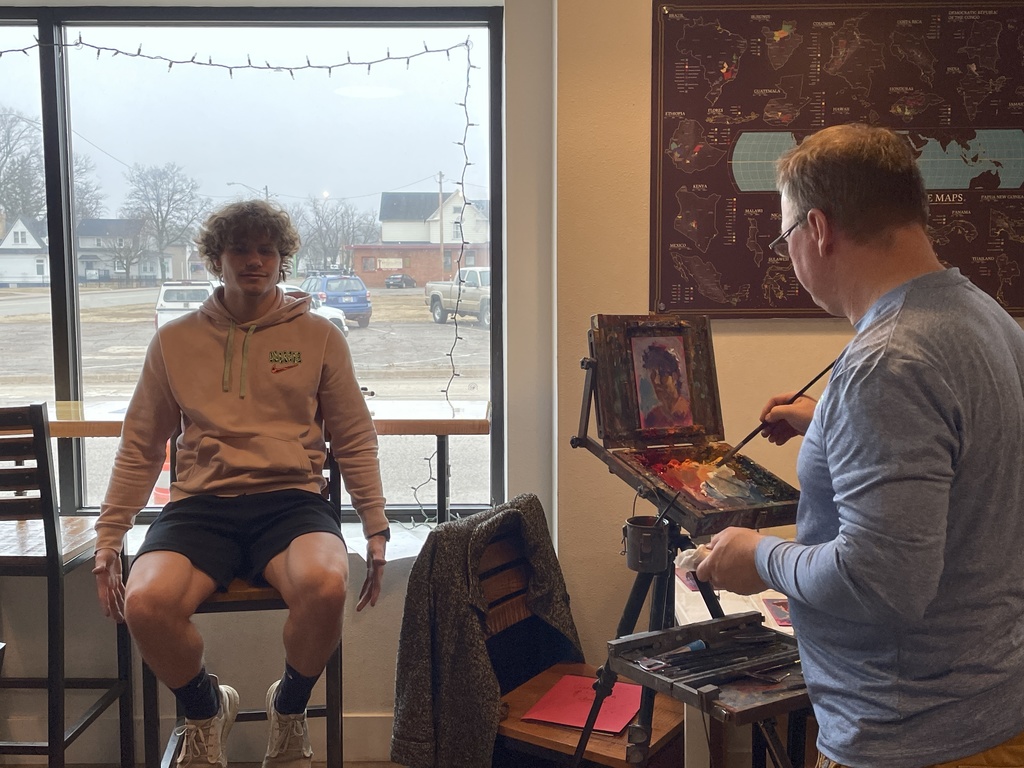 Patrick Millan having potrait done by painter steven wysocki