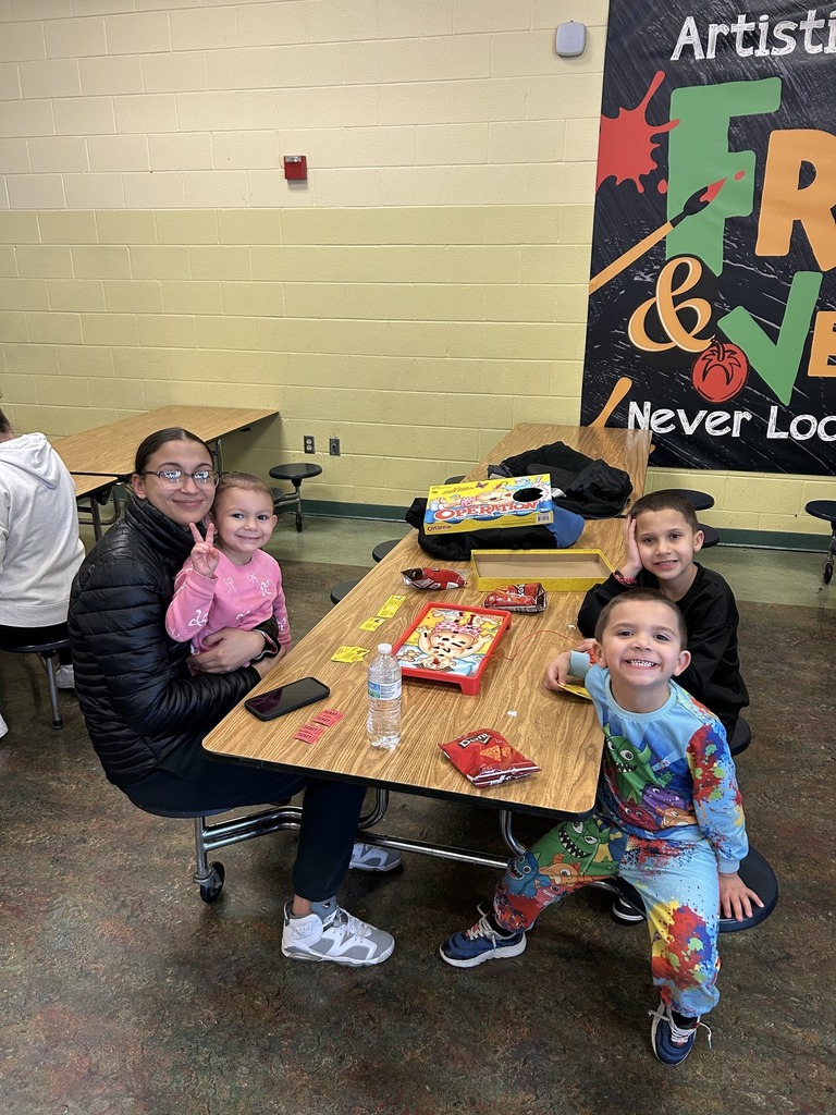 Kids and adults playing a board game.
