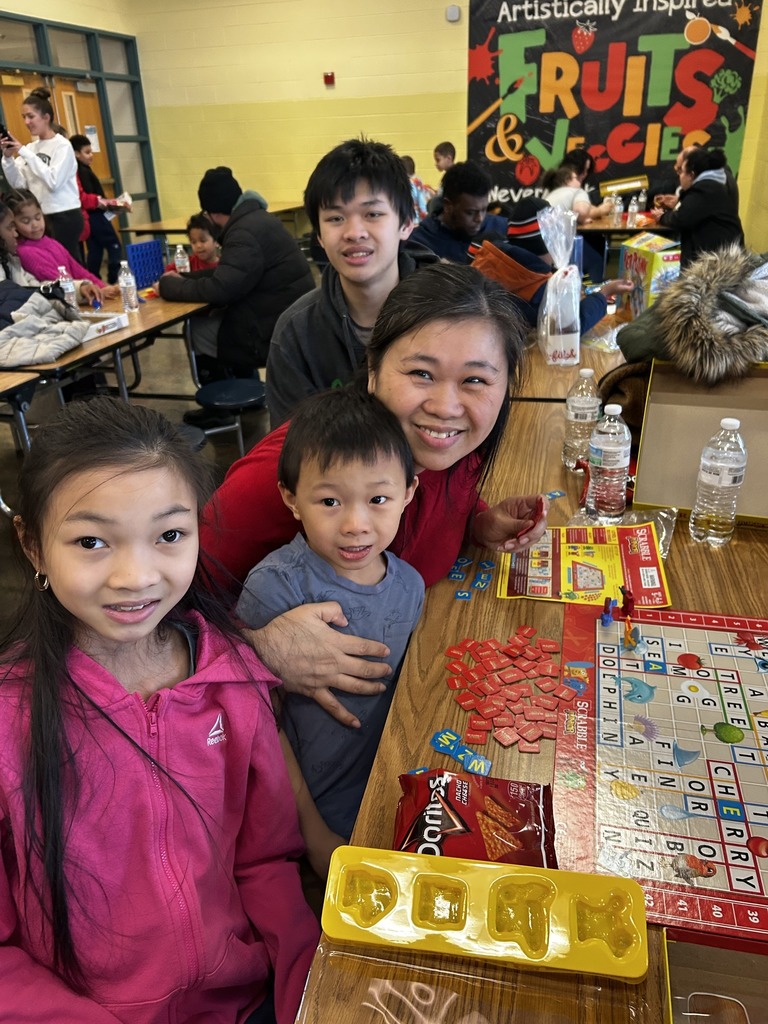 Kids and adults playing a board game.