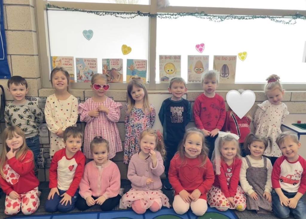 kids sitting in rows on the floor