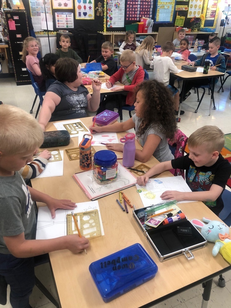 students in kindergarten working on tracing shapes