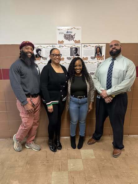 Four African American adults standing in the hall.