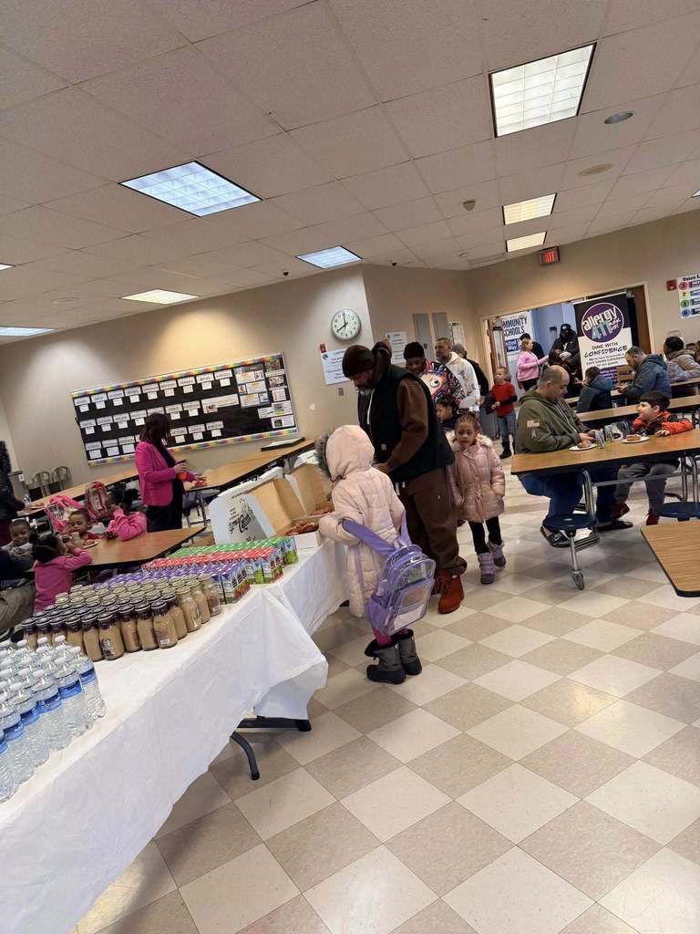 People standing in line to get donuts.