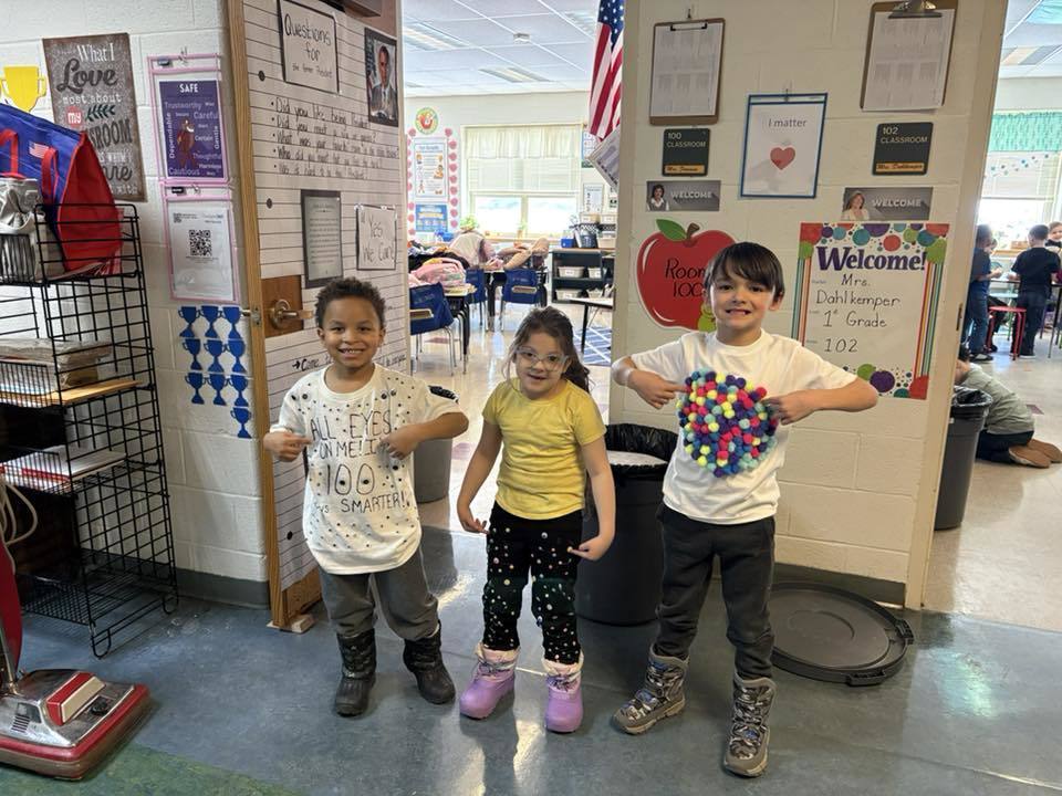 Kids wearing clothing that has dots on it. 