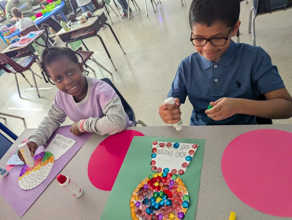 Students coloring and decorating a design with dots. 
