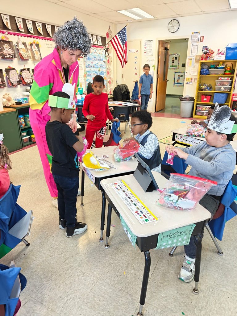 Teacher wearing bright color clothing helping students in class. 