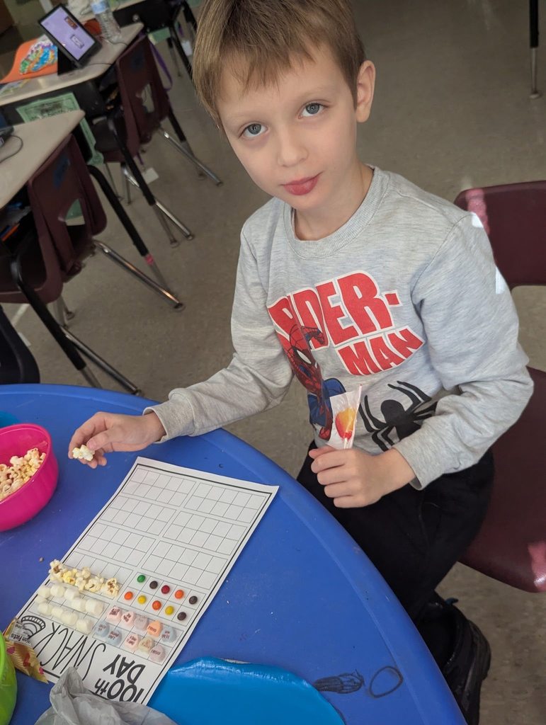 Student doing an activity with snacks and paper. 