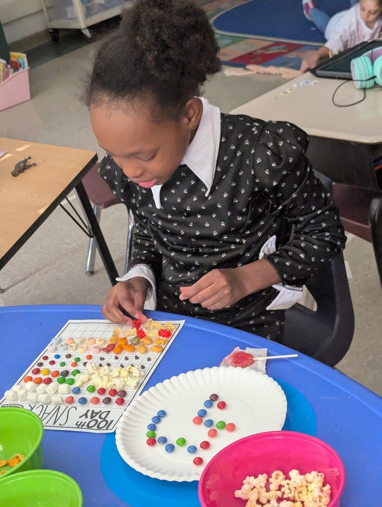 Student doing an activity with snacks and paper. 