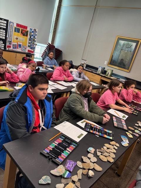 A classroom with students sitting at tables. 