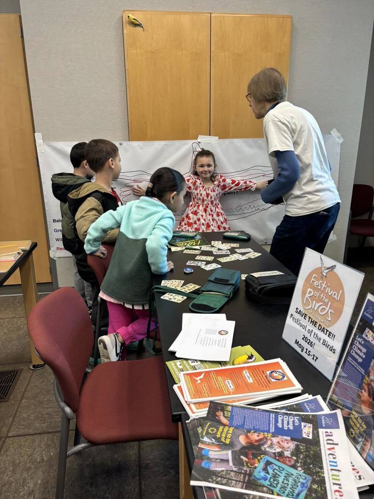 A group of kids and adult doing an activity. 