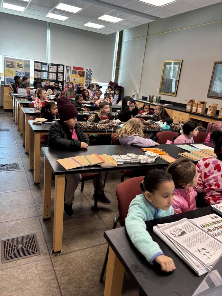 A classroom with students sitting at tables. 
