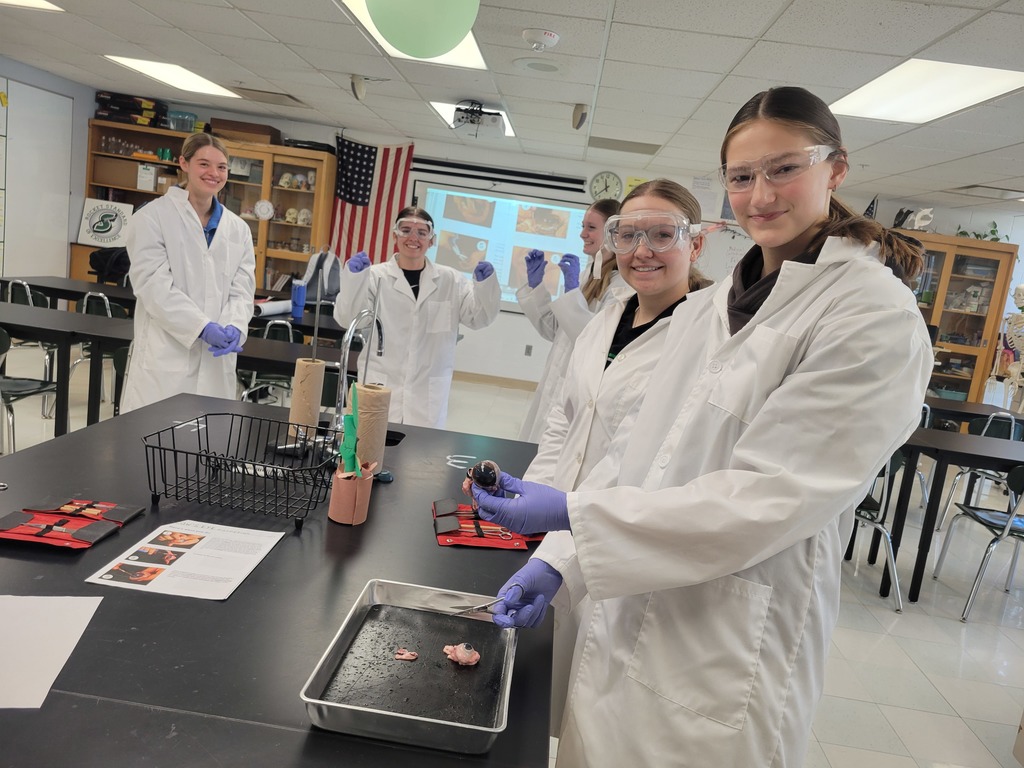 This lab group shows off their cow eye. 