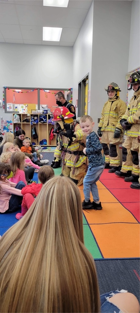preschool students with firefighters 
