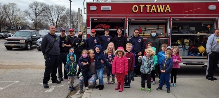 students posing with a fire truck 