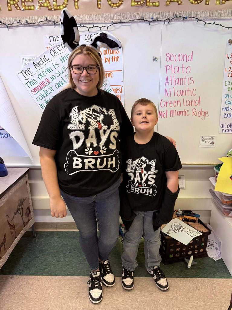 A teacher and student wearing shirts that recognize that it is the 101 day of school. 