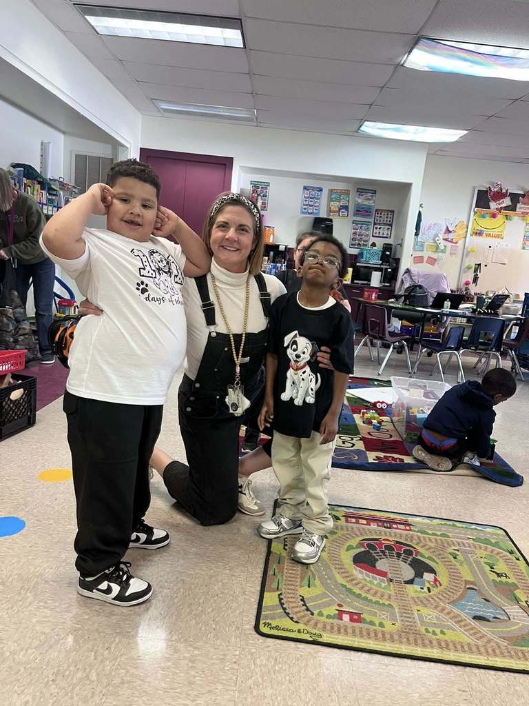 A teacher and students wearing shirts that recognize that it is the 101 day of school. 