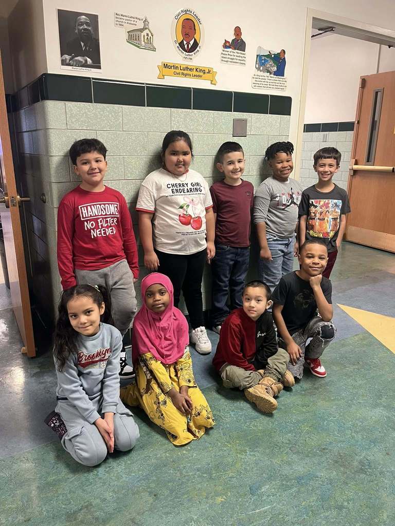 Students smling in the hall.