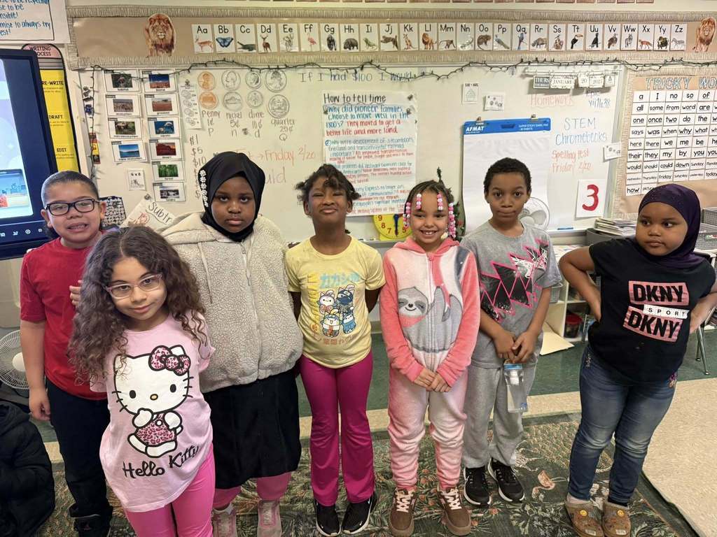 Group of students smiling in class. 