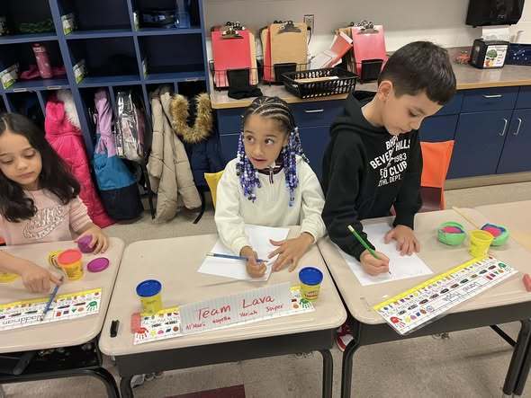 Kids cwriting and making crafts in class. 