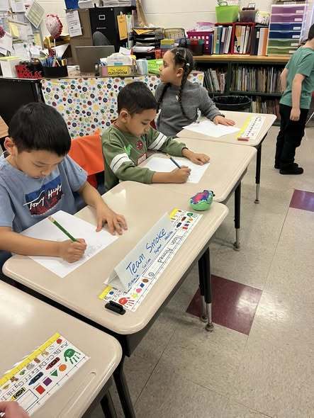 Kids writing in class.