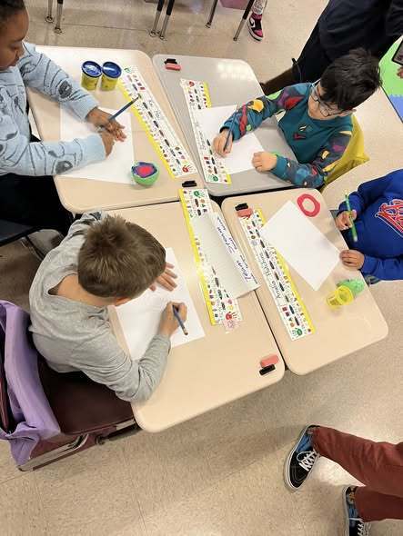 Kids coloring and making crafts in class. 