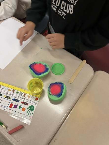 Kids making a craft using playdough. 