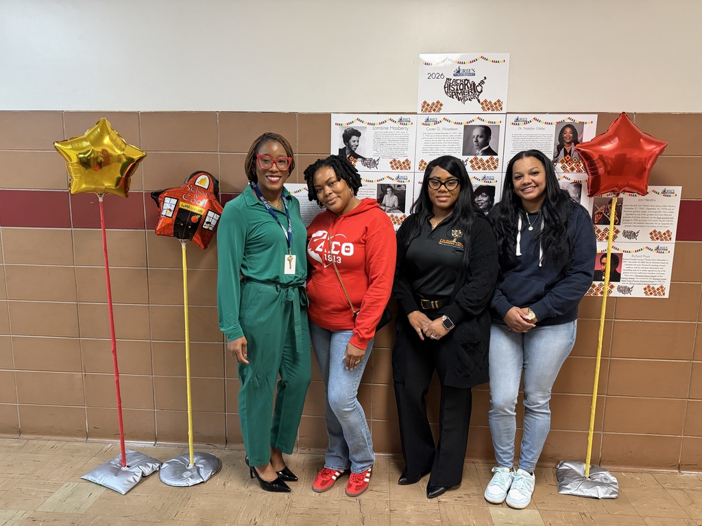 Four African American women standing in the hall and smiling.