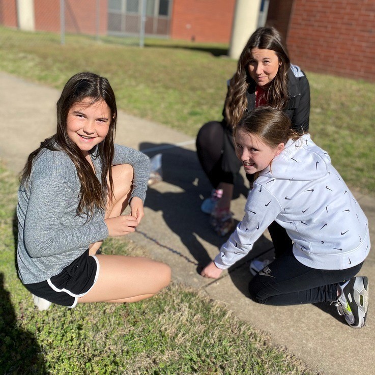 student laying coins down