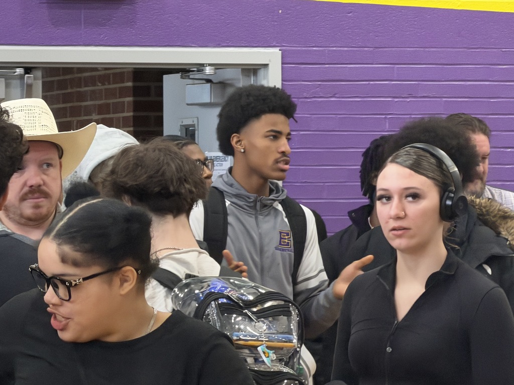 Students talking to different companies at a career fair.