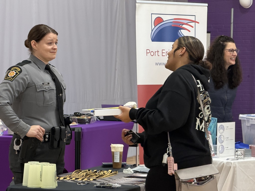 Students talking to different companies at a career fair.