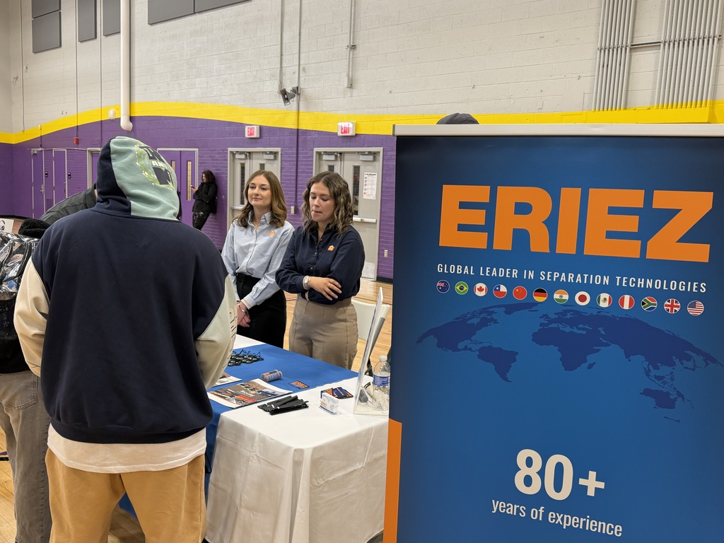 Students talking to different companies at a career fair.