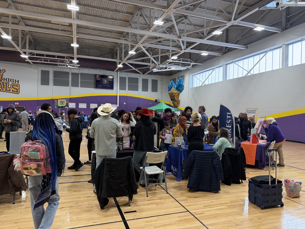 Students talking to different companies at a career fair.