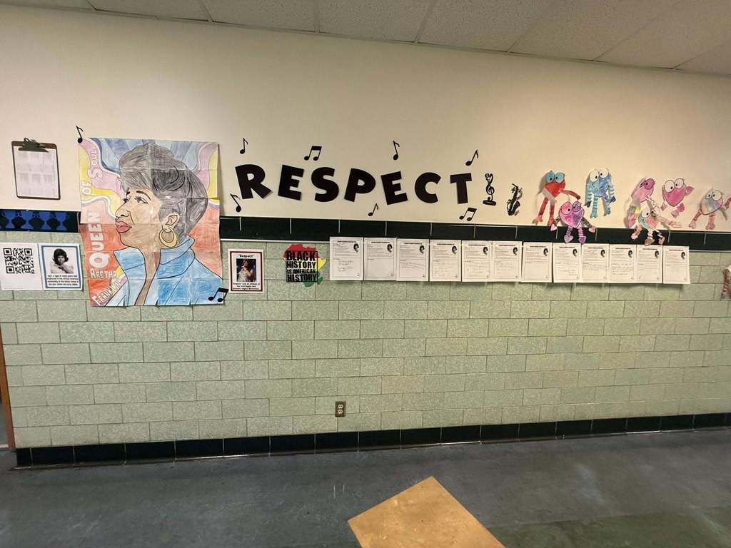 Respect displayed on a wall with art around it. 