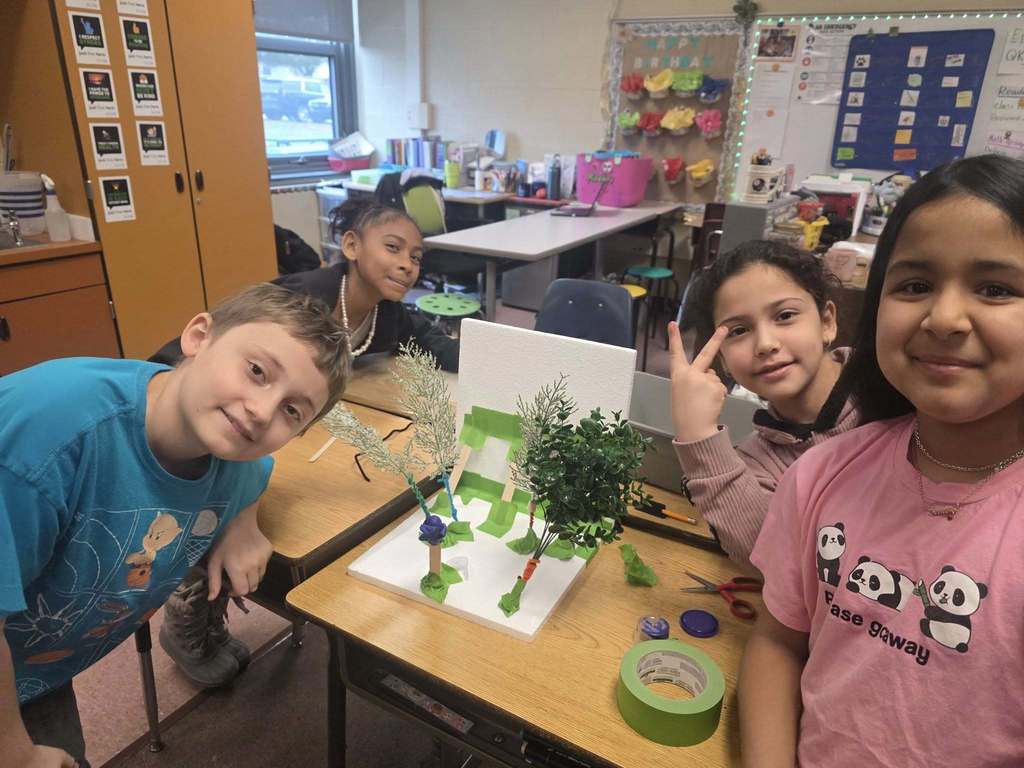 Kids working on a windbreaker kit in science class.