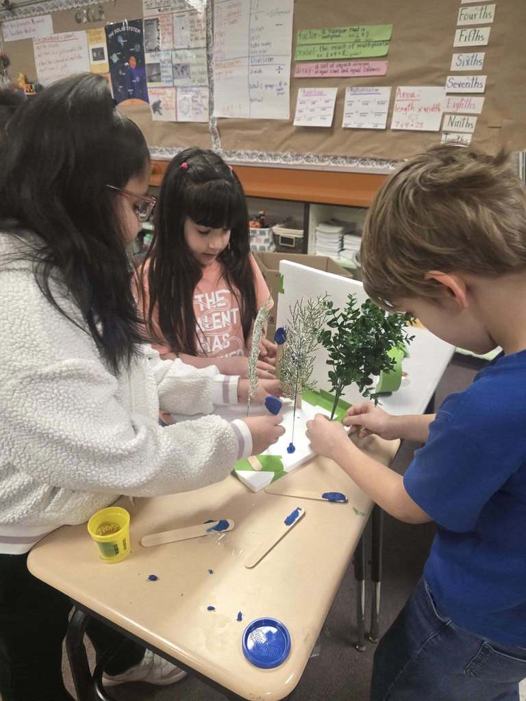 Kids working on a windbreaker kit in science class.