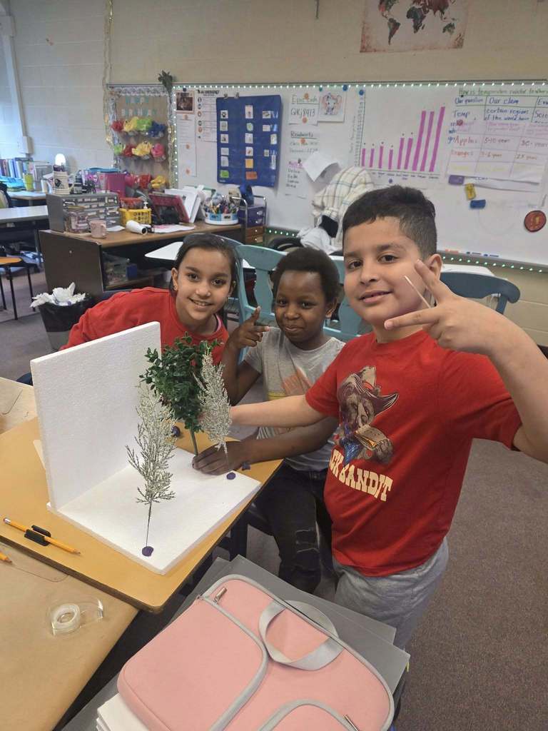 Kids working on a windbreaker kit in science class.