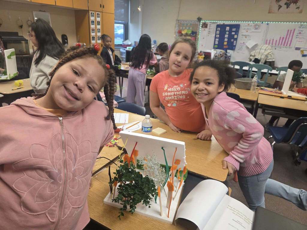 Kids working on a windbreaker kit in science class.