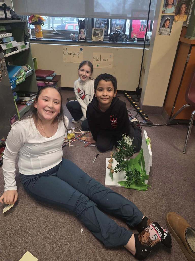 Kids working on a windbreaker kit in science class.