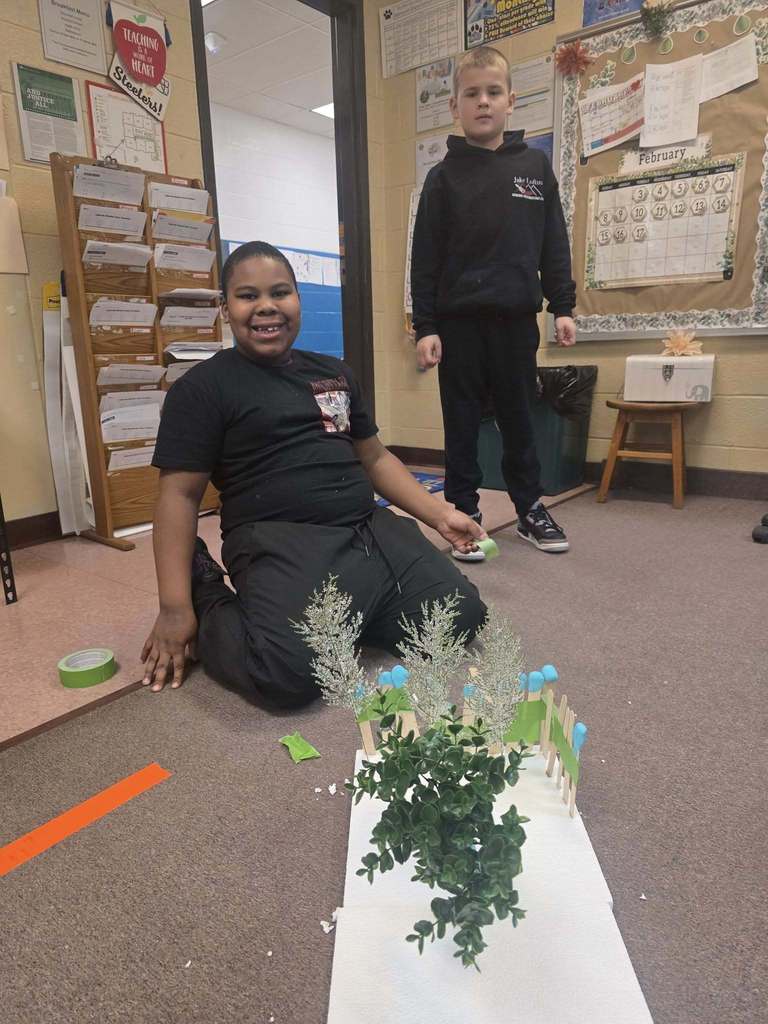 Kids working on a windbreaker kit in science class.