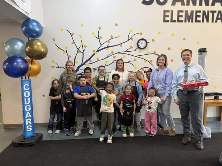 Students and staff accepting donuts from Erie News Now. 