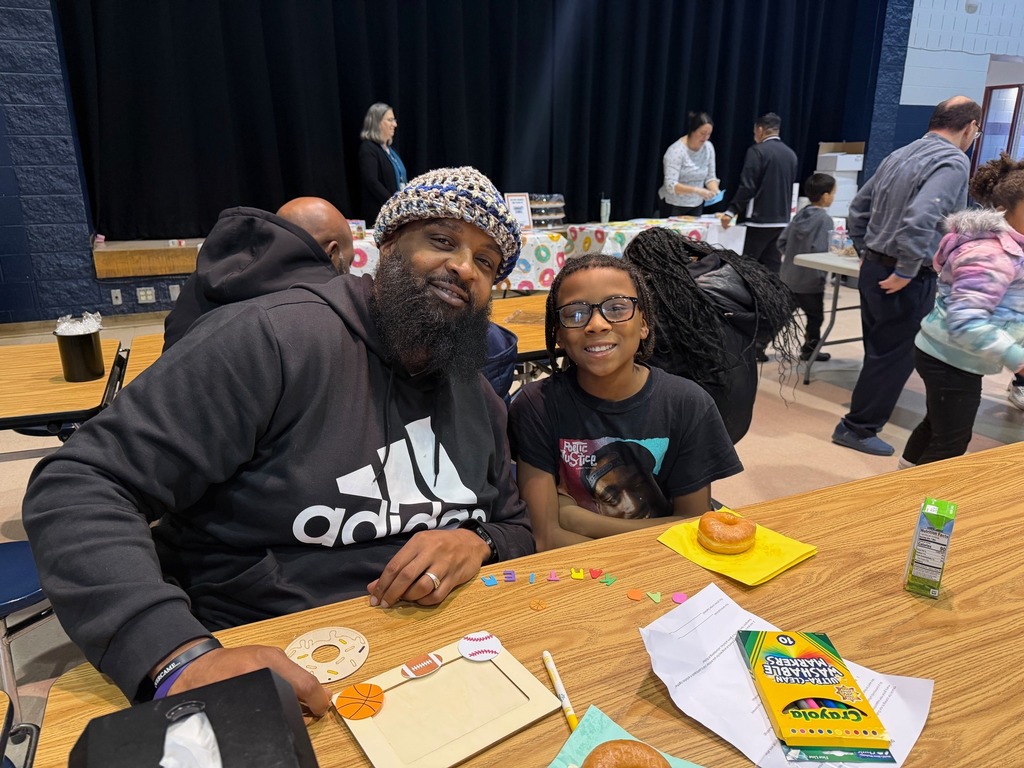 A student and man making a picture frame. 