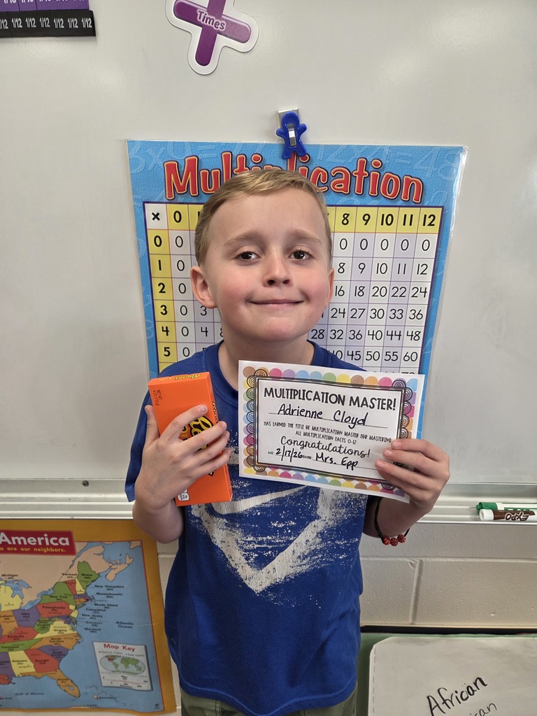 Adrienne smiling with his multiplication certificate