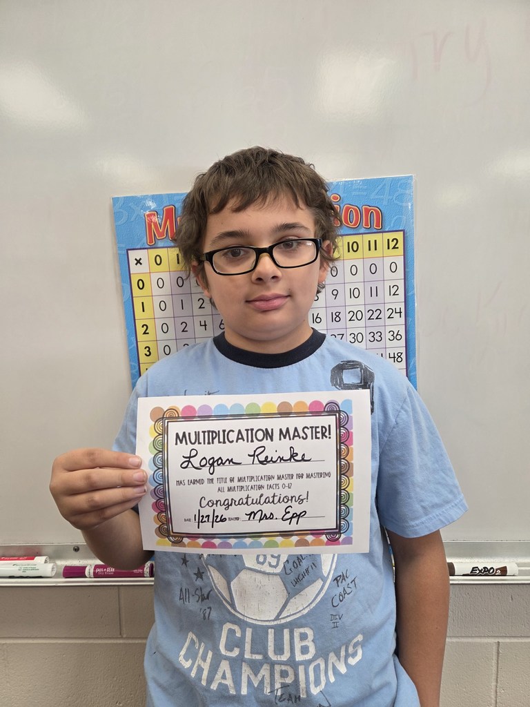 Logan smiling with his multiplication certificate!