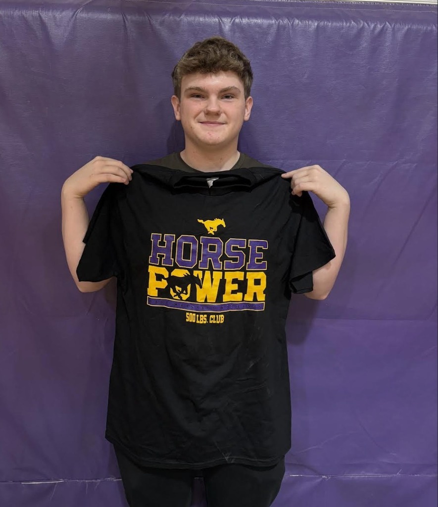 Noah S. holding a Horse Power shirt